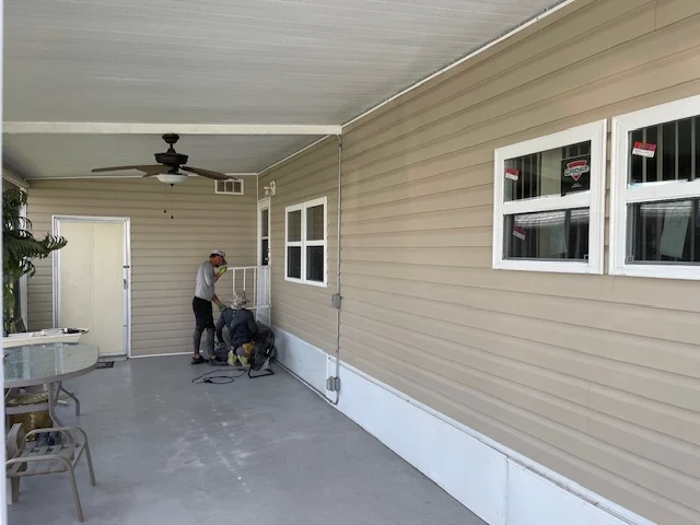Finished beige siding and window trim in St. Petersburg.