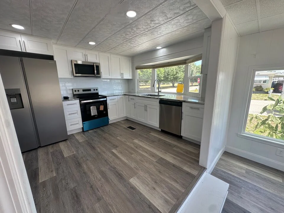 Completed RFH kitchen renovation with white cabinets and new flooring