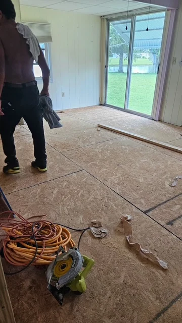 An opened-up room during subfloor repair work.